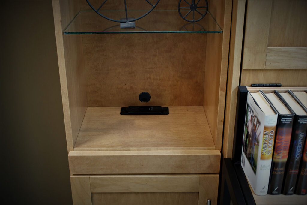 Charging station in BookcaseAdded to the back of a 13-7/8" depth bookcase.  Placed right above the pull-out drink tray.