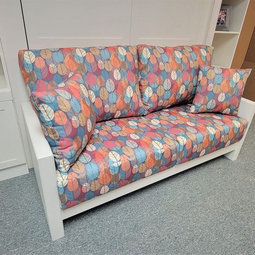 close up of the white Murphy bed Sofa with colorful print